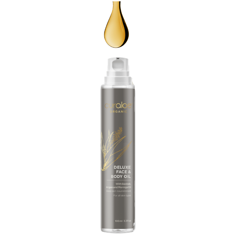 Bottle of Curaloe Deluxe Face & Body Oil with a droplet above on a white background