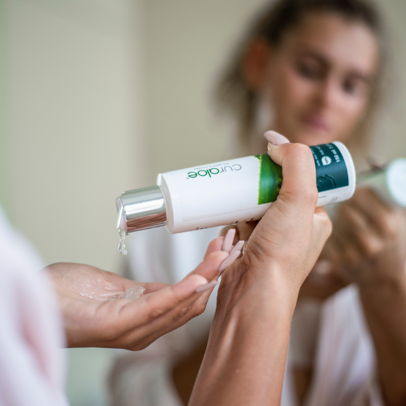 Person applying Curaloe Facial Gel