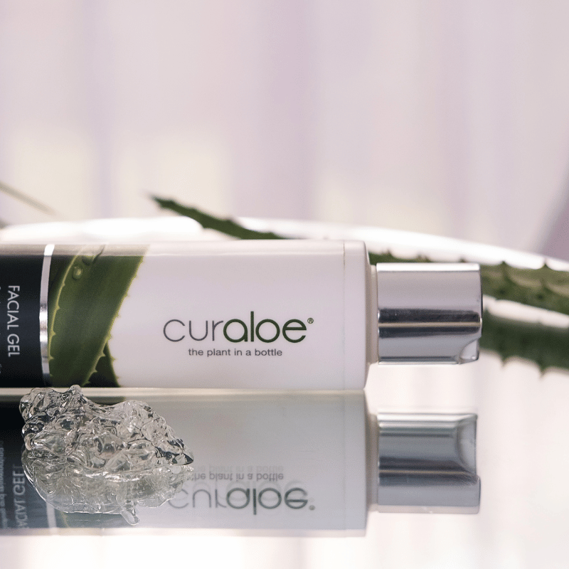 Curaloe facial gel packaging with aloe vera leaf on a white background