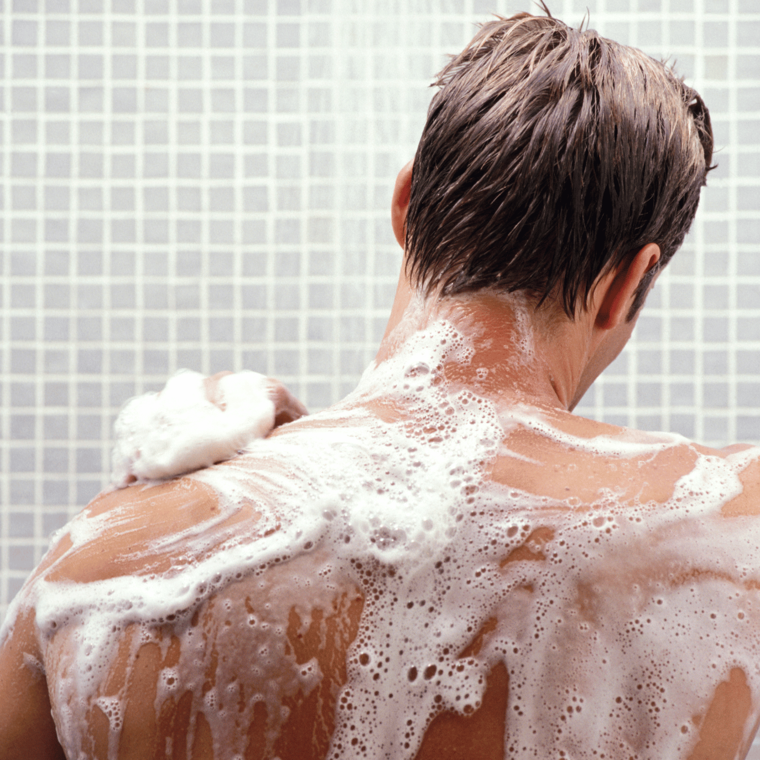 Person with soapy back in a shower setting
