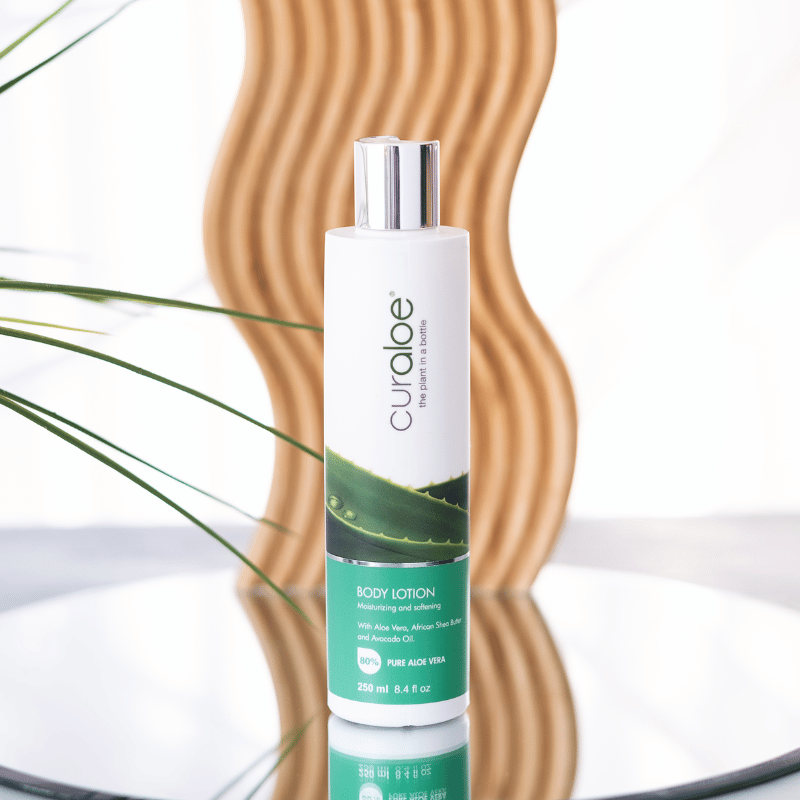 Curaloe body lotion bottle with aloe vera leaf design on a white background